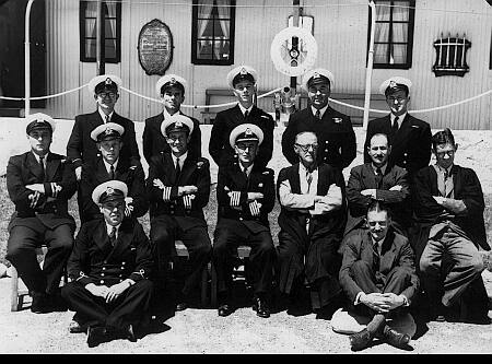 Ships Staff 1951Back row [Left to Right]: Mr. F. J. Morris [Executive Instructor, Shipwright]; Mr. J. A. Almond [Chief Executive Instructor]; Mr. H. E. Pinn [Navigation Officer]; Mr. B. A. L. McGee [Executive Instructor, Seamanship]; Mr. J. H. Smith [Physical Training Instructor];